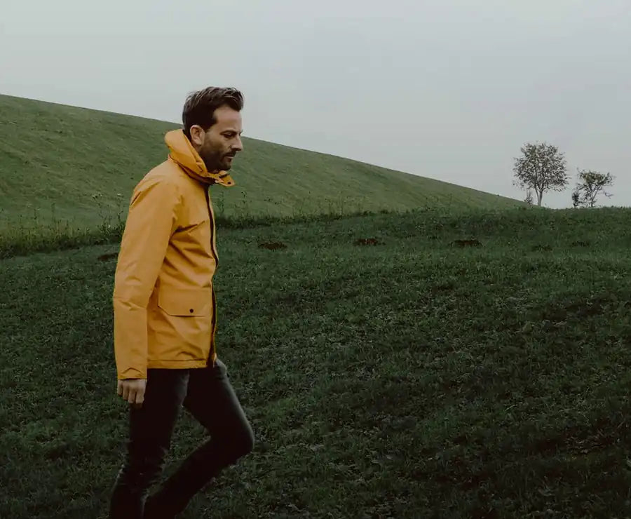 Man walking through a green landscape